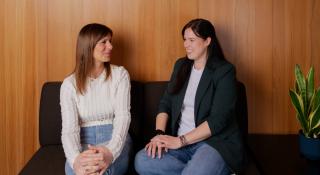 Twee personen zitten naast elkaar op een bank